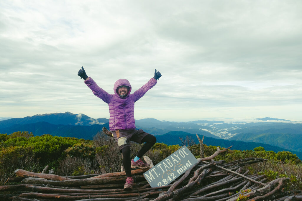 James on the summit of Mt. Tabayoc beside the 2842 masl sign